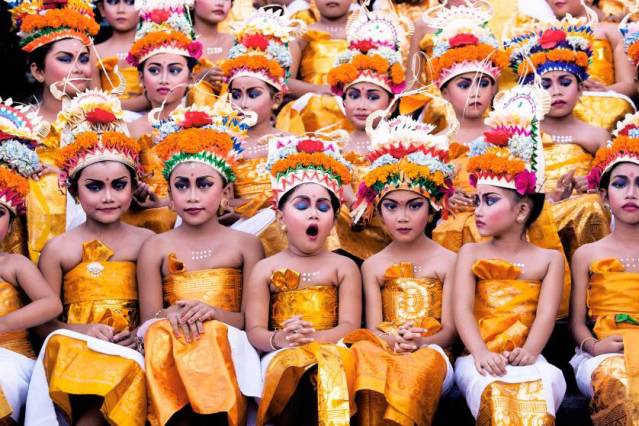 Image was taken in Bali during Melasti Festival. This Festival is conducted once a year in conjunction with Nyepi or Silent Day. These young girls were waiting for their turn to perform. They looked stunning with their bright coloured costumes and heavy make-up on, however the expression on each of the girls' face especially the yawning girl gives this image an extra 'ummpph'.